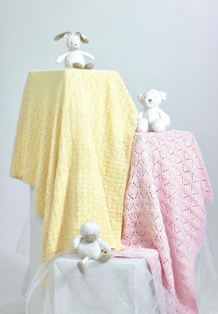 Picture shows a yellow blanket in a basket weave stitch and a pink blanket with a lacy diamond shapes finish/